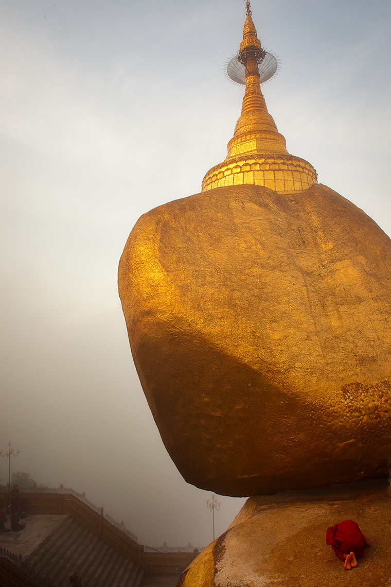 Buddhist Monk Praying In Front of Golden Rock, Kyaktiyo, Burma